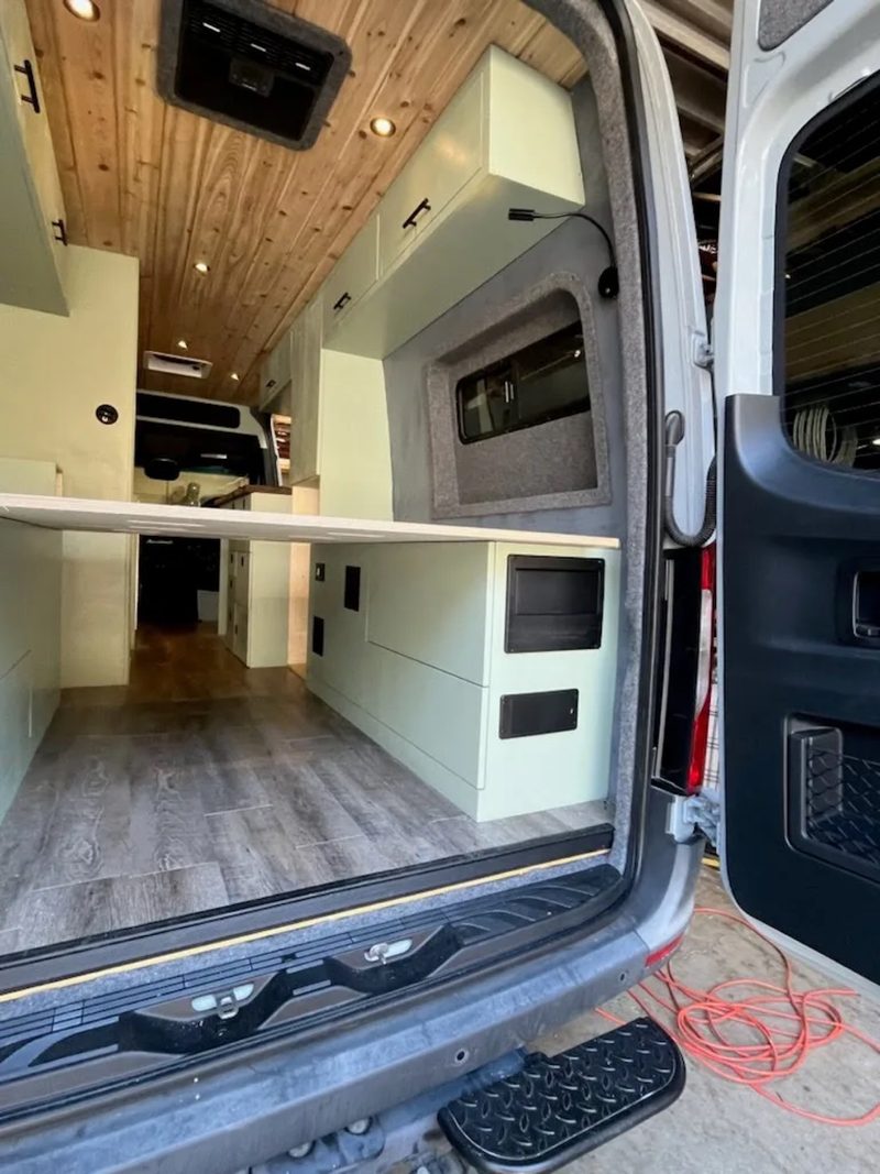 Garage cabinets with bed panels in the back of a van
